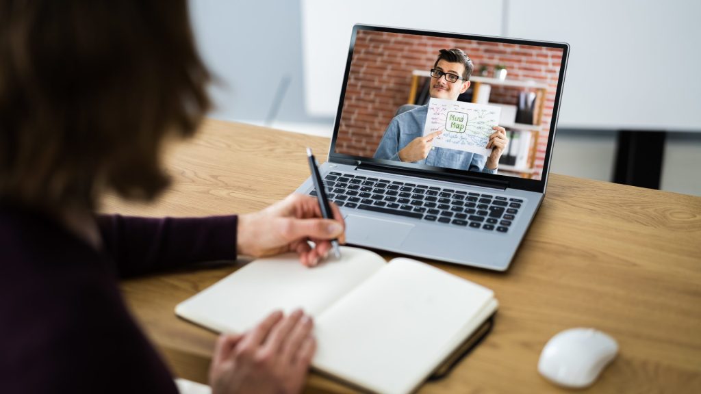 virtual-assistant-using-a-notebook-and-pen-to-record-important-details-from-a-meeting