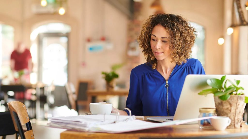 fueled-by-caffeine-and-productivity-picture-a-virtual-assistant-slaying-their-to-do-list-from-a-cozy-café-surrounded-by-a-steaming-cup-of-joe-organized-binders-and-a-trusty-laptop-no-task-is-too-big-for-this-multitasking-master