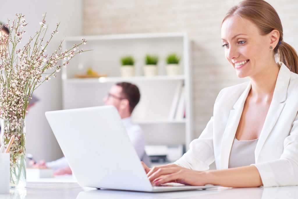 pretty-woman-typing-on-laptop-at-office