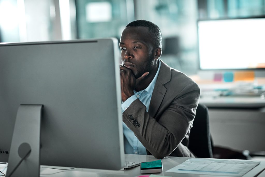 a-man-sitting-at-a-desk-in-front-of-a-computer-perfect-face-template-adebanji-alade-garnishment-obelisks-low-energy-thinking-trending-on-markets-black-and-cyan-color-scheme-stressing-out-monitors