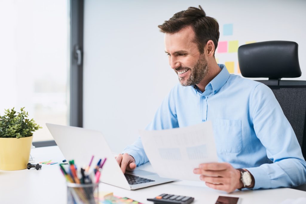 happy-businessman-doing-data-entry-work-at-office