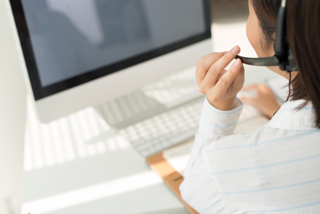 a-woman-sitting-at-a-desk-in-front-of-a-computer-have-a-call-to-action-connecting-lines-silvergill-adept-hgh-fined-detail-wlop-|-intecrate-details-call-now-utradetailed-closed-visor-full-details-a-stock-photo-more-details-overecast-dials-formline